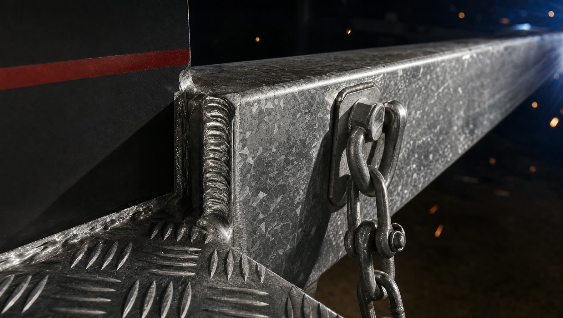 Macro detail of a welded galvanised steel trailer chassis joint